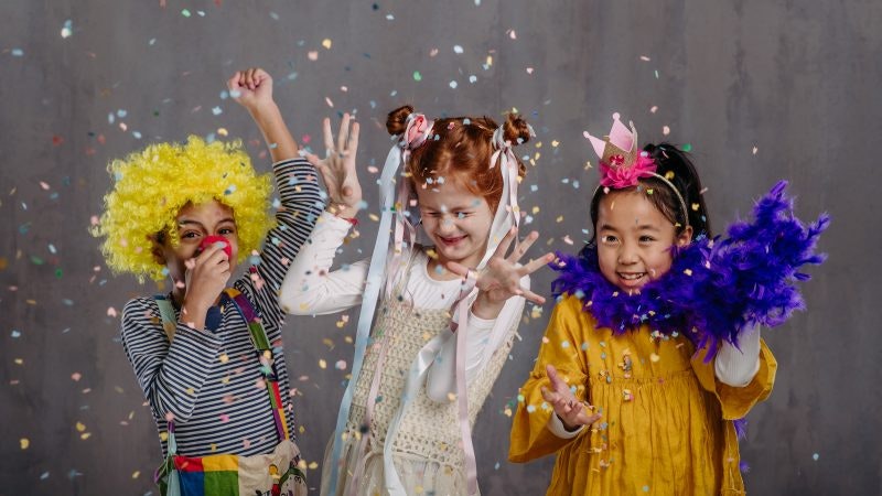 Portrait of three children in funny costumes.